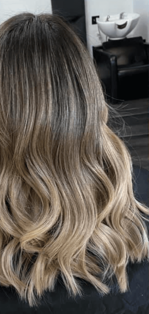 Blonde hair with wavy texture in a salon setting
